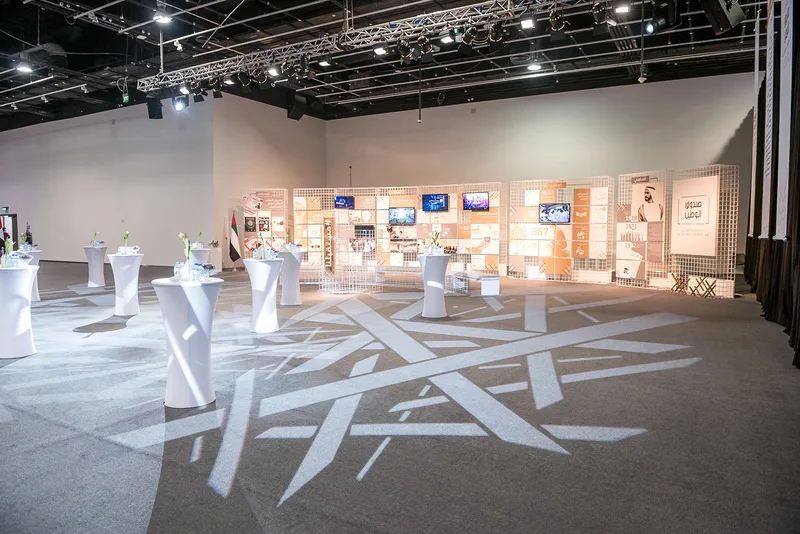 Interactive exhibition gallery displaying student innovation projects on custom plinths