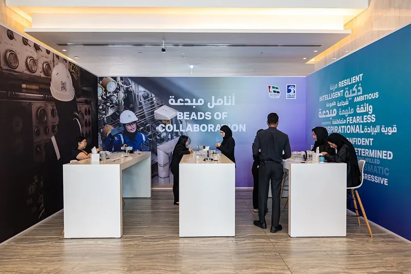 Interactive workshop zone with high-top tables and motivational word wall for corporate event delegates