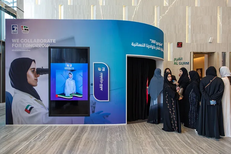 Queue of delegates at 360 photo booth activation with live preview screen produced by Evolution