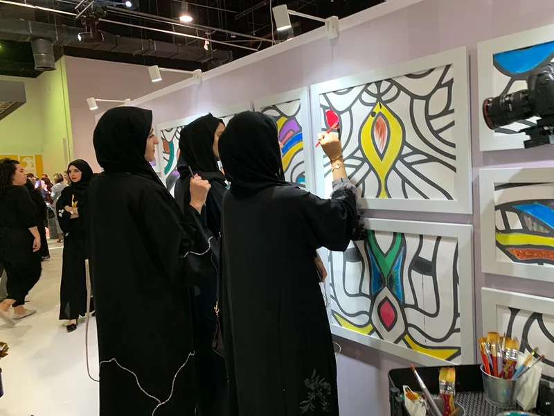 Wide-angle shot of Abu Dhabi venue hall filled with delegates during Emirati Women's Day celebration