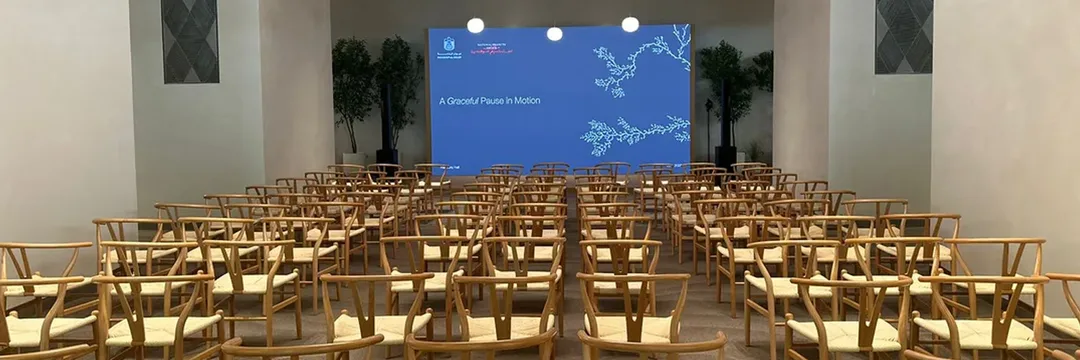 An anniversary environment at Erth Hotel combining Atolye’s design language with framed project stories, custom branding, floral detail and integrated AV.