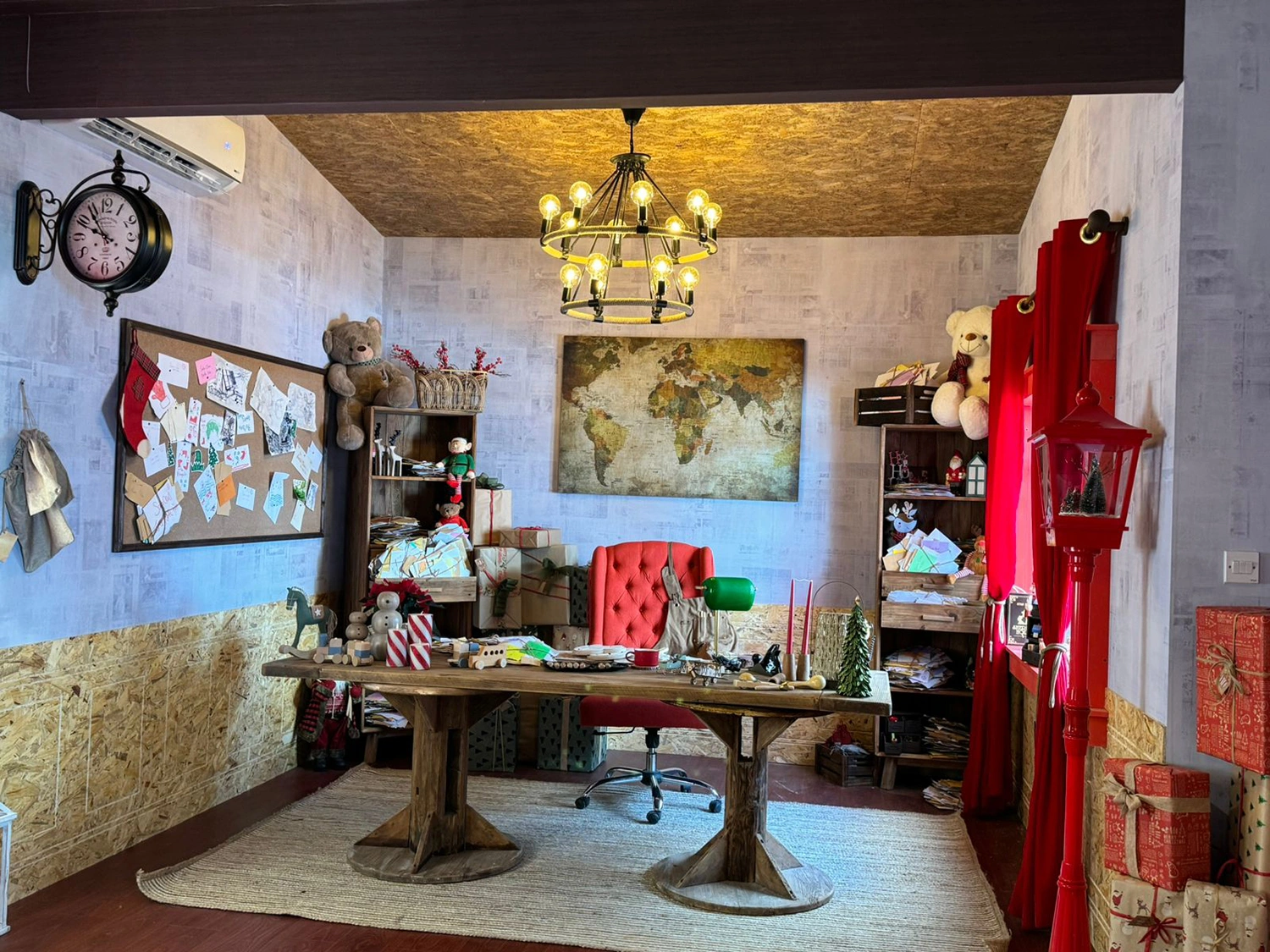 Rustic desk, world map and children’s letters inside Santa’s Sustainable House