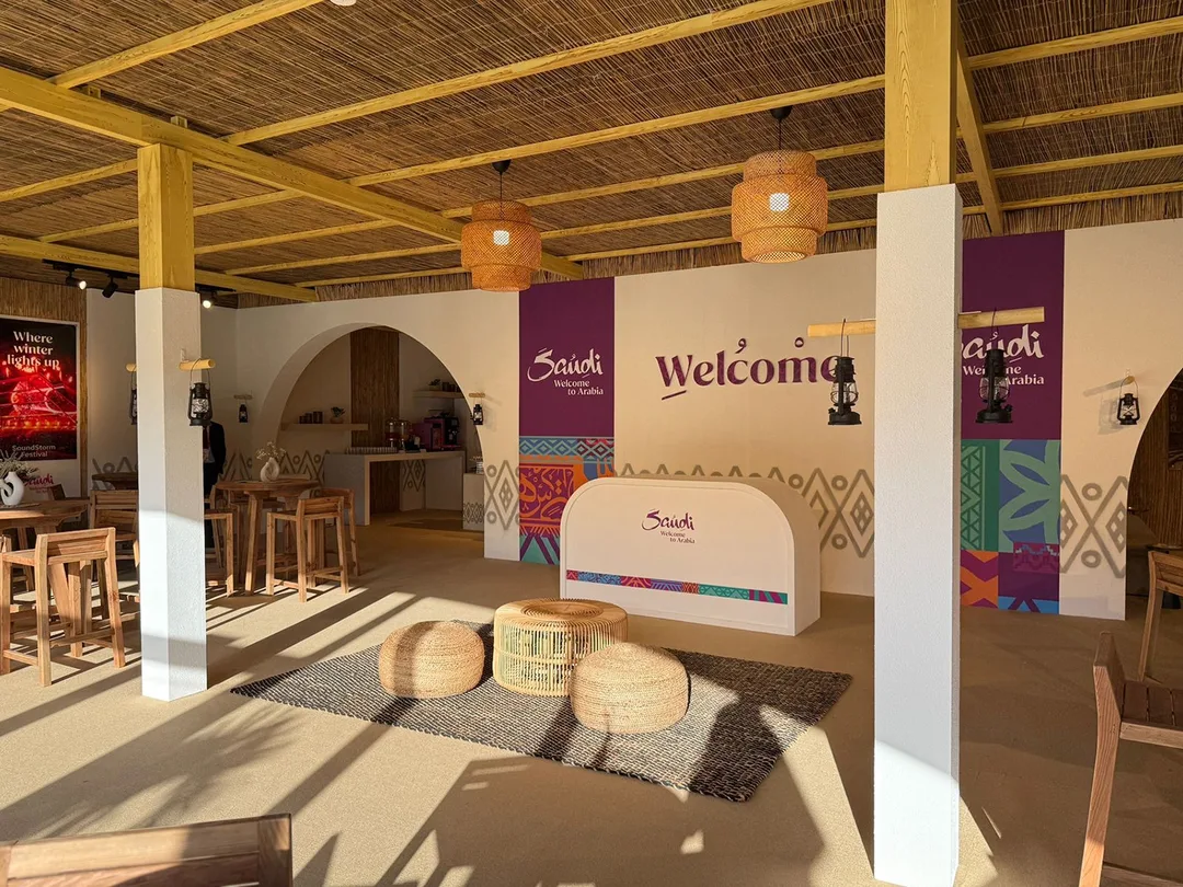 A temporary VIP tent transformed into a refined Visit Saudi hospitality environment, supported by a coordinated welcome presence at Emirates Dubai 7s.