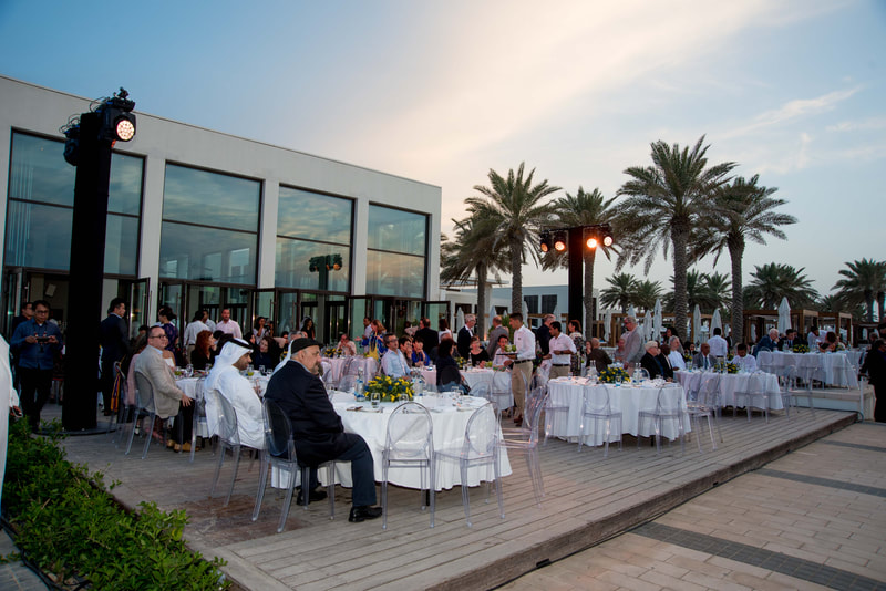 People seated outside at a gala dinner