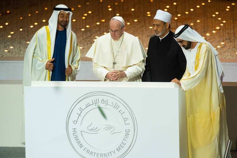 Image of Pope Francis and The Grand Imam of Al-Azhar Ahmad Al-Tayyeb, alongside 2 rulers of the UAE standing at a podium
