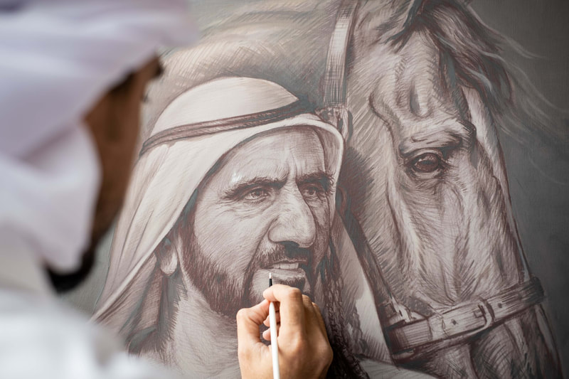 Artist completing his work on a portrait of His Highness Sheikh Mohammed Bin Rashid Al Maktoum and a Horse.
Mixed Medium, Pencil and paint. Portraiture.
