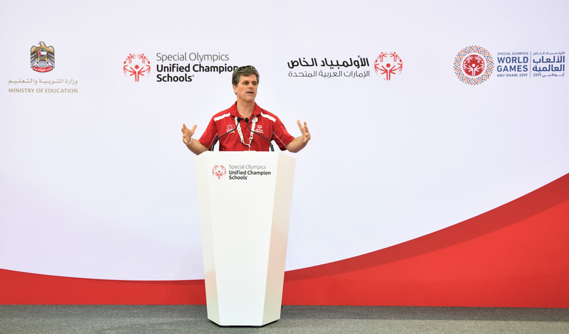 Man speaking at lectern for the Special Olympics Unified Champions Campaign