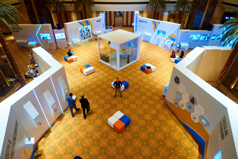 Isometric view of an exhibition area, brightly colored with bespoke furniture