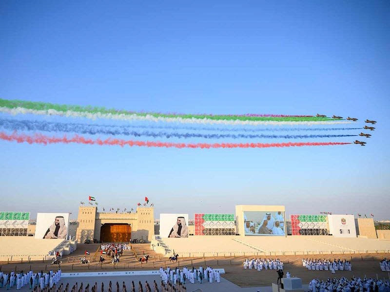 Planes flying over a grandstand with the UAE flag as a backdrop